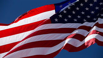 american flag waving on a blue background