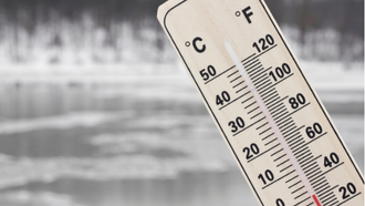 Thermometer showing 30 degrees with a frozen lake in the background